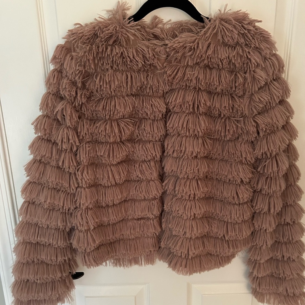 Light weight faux fluff jacket. Waist length hook and eye closure.